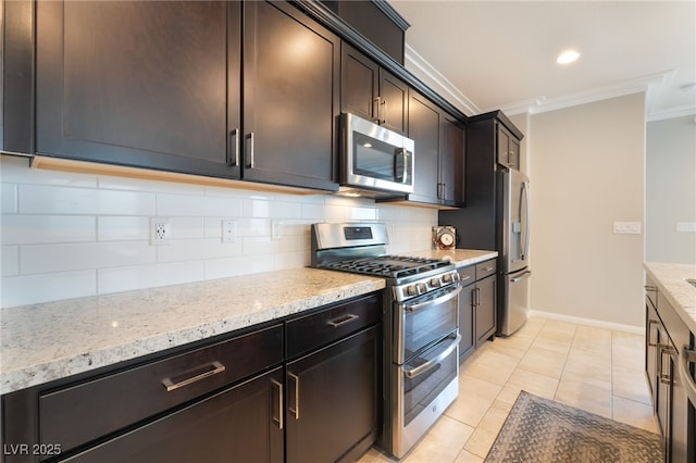 12478 Dolan Point St, Las Vegas, NV 89138 - kitchen featuring stainless steel appliances, crown molding, decorative backsplash, light stone countertops, and light tile patterned flooring