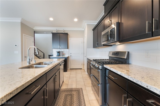 12478 Dolan Point St, Las Vegas, NV 89138 - kitchen featuring appliances with stainless steel finishes, crown molding, tasteful backsplash, light stone counters, and light tile patterned floors