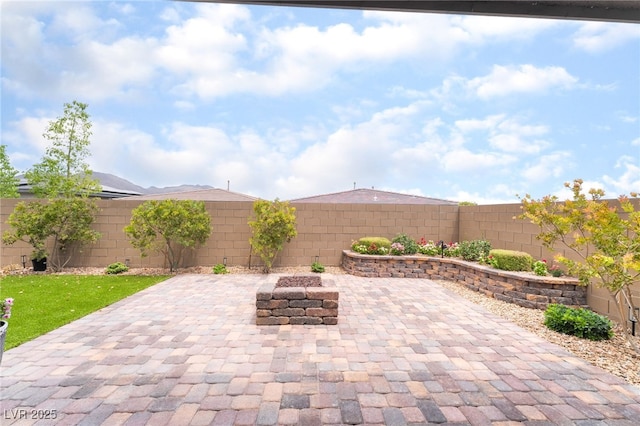 12478 Dolan Point St, Las Vegas, NV 89138 - fenced backyard featuring a patio and an outdoor fire pit