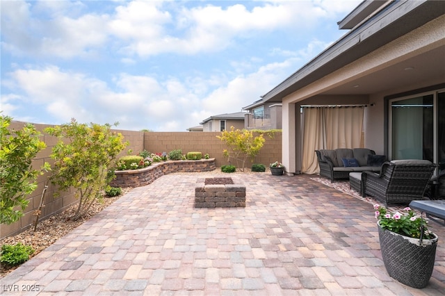 12478 Dolan Point St, Las Vegas, NV 89138 - fenced backyard featuring a patio area and an outdoor living space with a fire pit