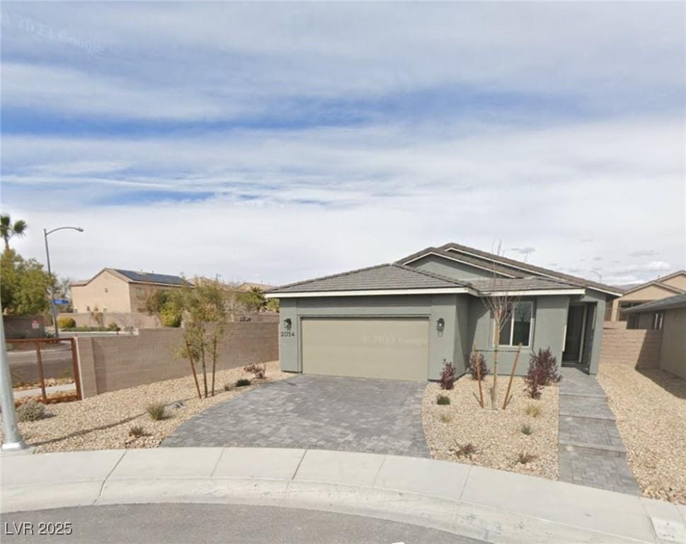 2014 Millergrove Ave, North Las Vegas, NV 89086 - ranch-style home with an attached garage, decorative driveway, and stucco siding