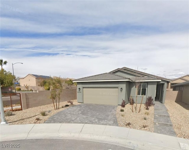 2014 Millergrove Ave, North Las Vegas, NV 89086 - ranch-style home with an attached garage, decorative driveway, and stucco siding