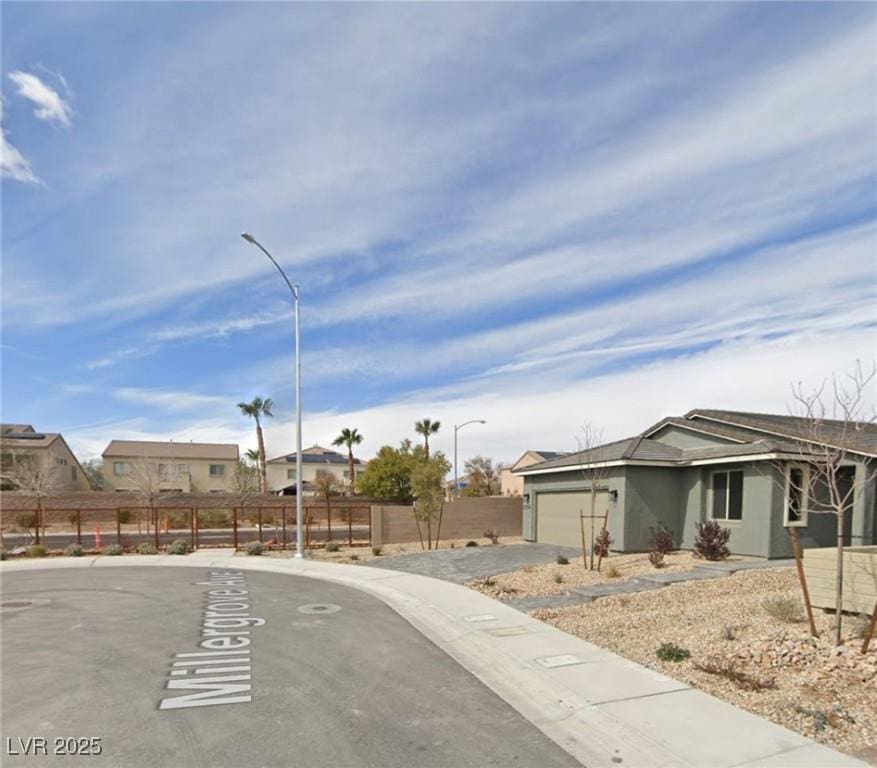 2014 Millergrove Ave, North Las Vegas, NV 89086 - view of asphalt street with street lighting, sidewalks, and curbs