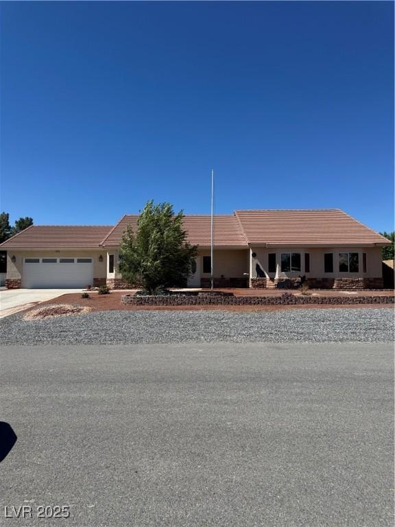 5410 Fernwood Ct, Pahrump, NV 89061 - ranch-style home with a tile roof, driveway, and an attached garage