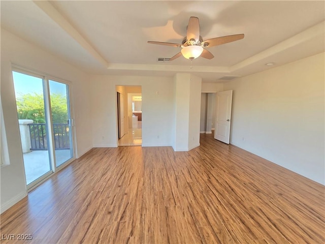 7428 Timber Run St, Las Vegas, NV 89149 - spare room with a tray ceiling, light wood-type flooring, and ceiling fan