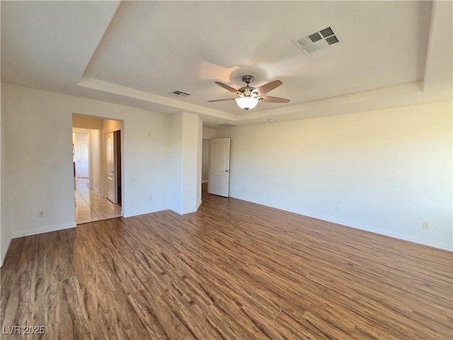 7428 Timber Run St, Las Vegas, NV 89149 - unfurnished room featuring a raised ceiling, wood finished floors, and a ceiling fan