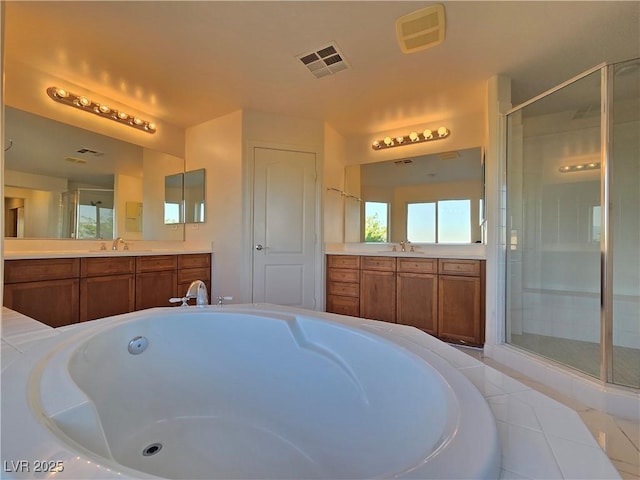 7428 Timber Run St, Las Vegas, NV 89149 - bathroom with two vanities, a garden tub, a shower stall, and tile patterned flooring