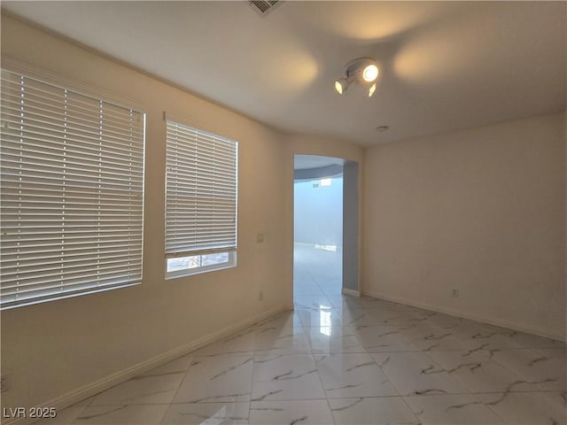 7428 Timber Run St, Las Vegas, NV 89149 - spare room with light marble finish floors and arched walkways