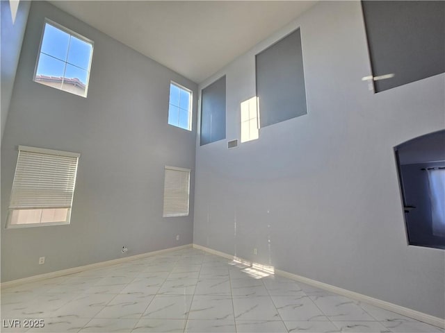 7428 Timber Run St, Las Vegas, NV 89149 - spare room with marble look tile flooring and a towering ceiling