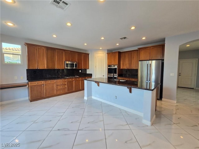 7428 Timber Run St, Las Vegas, NV 89149 - kitchen with stainless steel appliances, light marble finish floors, backsplash, recessed lighting, and a kitchen bar
