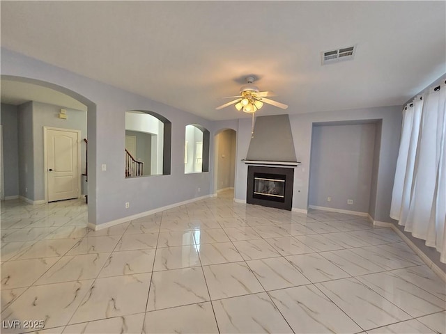 7428 Timber Run St, Las Vegas, NV 89149 - unfurnished living room featuring a ceiling fan, light marble finish flooring, and a large fireplace