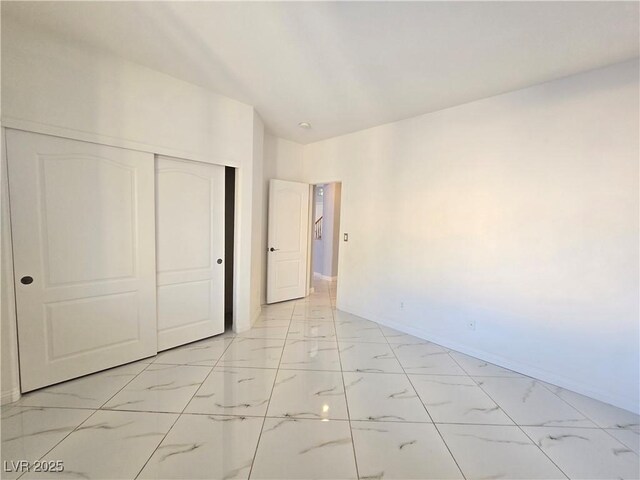7428 Timber Run St, Las Vegas, NV 89149 - unfurnished bedroom with light marble finish flooring and a closet