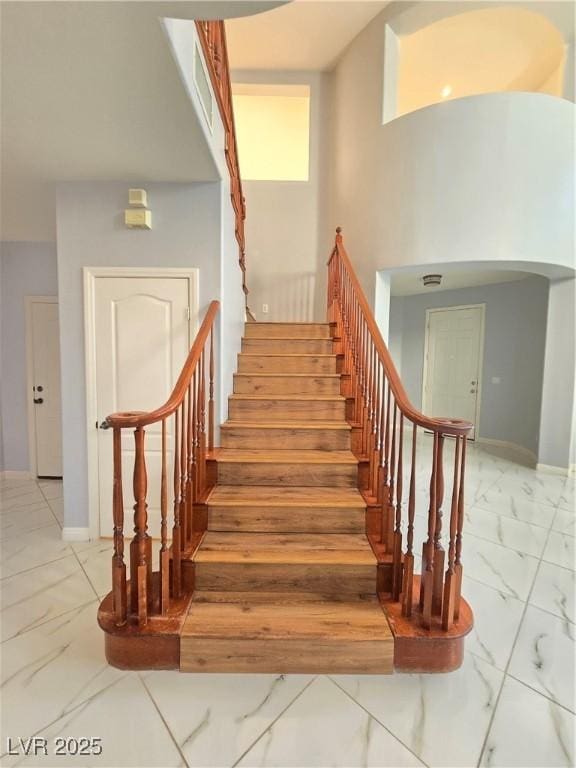 7428 Timber Run St, Las Vegas, NV 89149 - staircase with marble look tiles and arched walkways
