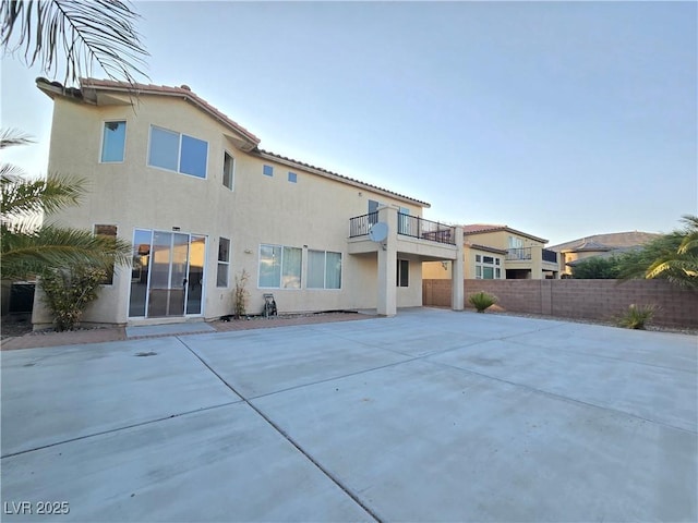 7428 Timber Run St, Las Vegas, NV 89149 - rear view of property featuring a balcony, stucco siding, and a patio