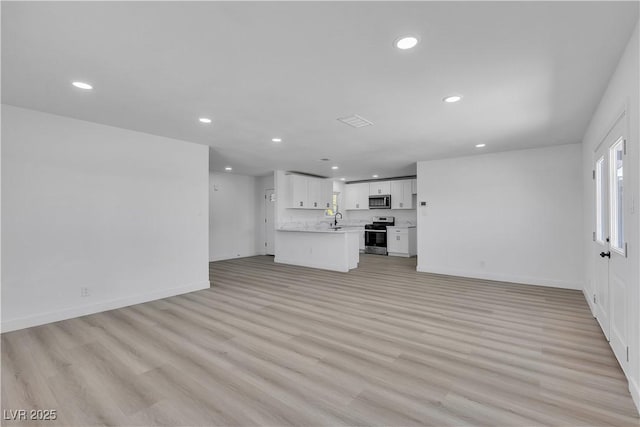 4186 Toronto Cir, Las Vegas, NV 89121 - unfurnished living room featuring recessed lighting and light wood-style floors