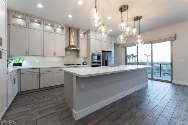4122 Yucca Bloom St Unit 0, Las Vegas, NV 89135 - kitchen featuring wall chimney exhaust hood, appliances with stainless steel finishes, backsplash, light countertops, and dark wood-type flooring