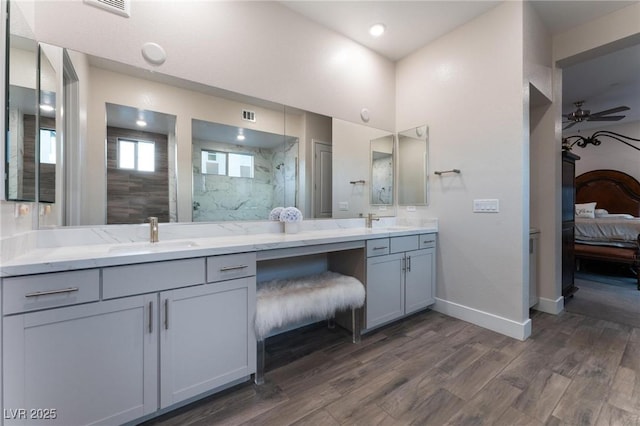 4122 Yucca Bloom St Unit 0, Las Vegas, NV 89135 - bathroom featuring ensuite bath, wood finished floors, double vanity, a marble finish shower, and recessed lighting