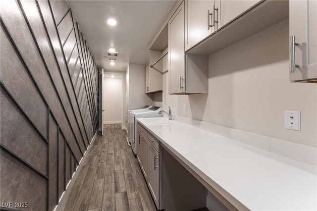 4122 Yucca Bloom St Unit 0, Las Vegas, NV 89135 - kitchen featuring dark wood-type flooring, washing machine and dryer, light countertops, and gray cabinetry