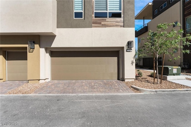 4122 Yucca Bloom St Unit 0, Las Vegas, NV 89135 - view of front of home featuring an attached garage, stucco siding, and driveway
