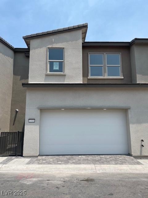 11418 Crimson Ledge Ave, Las Vegas, NV 89138 - view of front facade with a garage, stucco siding, and driveway