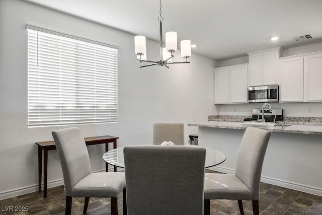 1110 Crystal Grotto Ave, North Las Vegas, NV 89081 - dining area featuring a chandelier, recessed lighting, and dark stone finish flooring