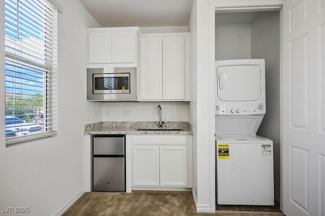 1110 Crystal Grotto Ave, North Las Vegas, NV 89081 - laundry area featuring stacked washer / drying machine and dark carpet