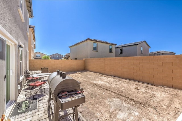 619 Harmony Rock Ave, North Las Vegas, NV 89081 - fenced backyard with grilling area and a patio