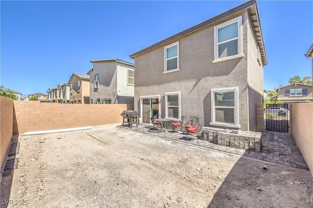 619 Harmony Rock Ave, North Las Vegas, NV 89081 - back of house featuring a fenced backyard, stucco siding, and a patio