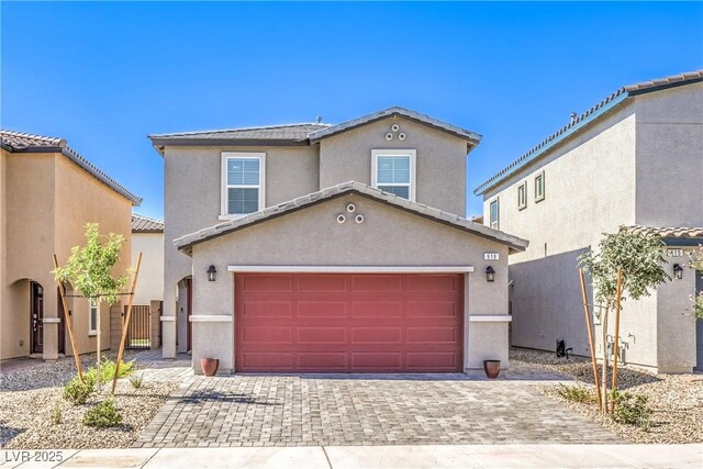 619 Harmony Rock Ave, North Las Vegas, NV 89081 - view of front of house with decorative driveway, stucco siding, a tile roof, and a garage