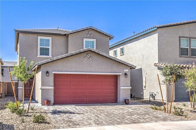 619 Harmony Rock Ave, North Las Vegas, NV 89081 - view of front facade featuring stucco siding, decorative driveway, a garage, and a tiled roof