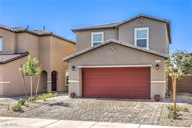 619 Harmony Rock Ave, North Las Vegas, NV 89081 - view of front of house with decorative driveway, stucco siding, a tile roof, and a garage