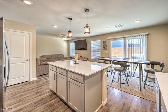 619 Harmony Rock Ave, North Las Vegas, NV 89081 - kitchen with stainless steel refrigerator with ice dispenser, dark wood-style floors, light countertops, hanging light fixtures, and recessed lighting