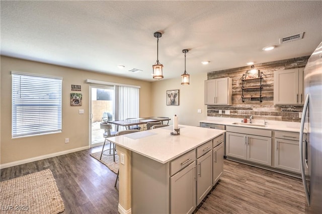 619 Harmony Rock Ave, North Las Vegas, NV 89081 - kitchen with gray cabinetry, tasteful backsplash, a center island, dark wood-style flooring, and light countertops