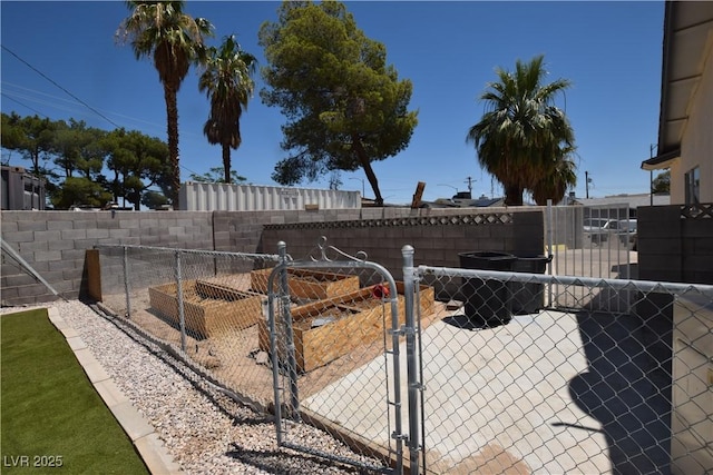 3323 Bancroft Cir, Las Vegas, NV 89121 - fenced backyard with a gate and a garden