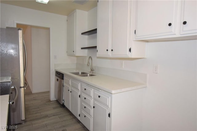 3323 Bancroft Cir, Las Vegas, NV 89121 - kitchen featuring stainless steel appliances, white cabinets, light wood finished floors, and light countertops