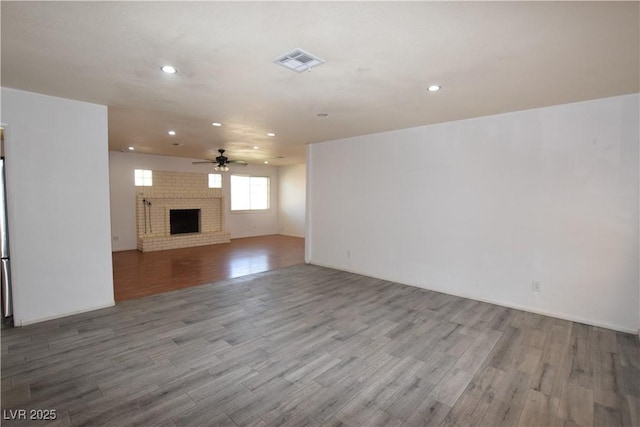 3323 Bancroft Cir, Las Vegas, NV 89121 - unfurnished living room with recessed lighting, a ceiling fan, wood finished floors, and a brick fireplace