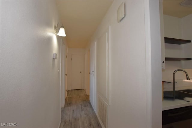 3323 Bancroft Cir, Las Vegas, NV 89121 - hallway featuring a sink and light wood-type flooring