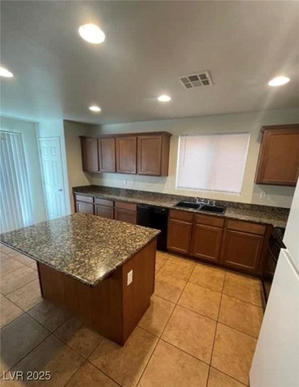 10225 Headrick Dr, Las Vegas, NV 89166 - kitchen with black dishwasher, a kitchen island, dark stone countertops, recessed lighting, and light tile patterned floors
