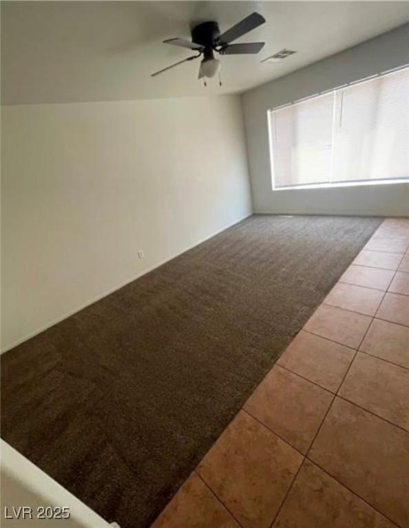 10225 Headrick Dr, Las Vegas, NV 89166 - tiled spare room with ceiling fan and carpet floors