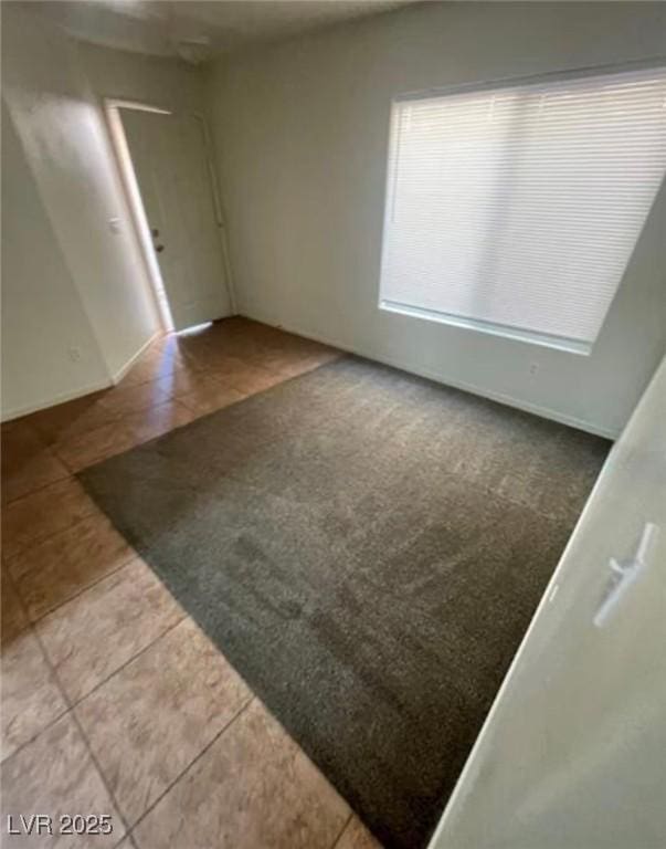 10225 Headrick Dr, Las Vegas, NV 89166 - spare room with tile patterned flooring and carpet floors