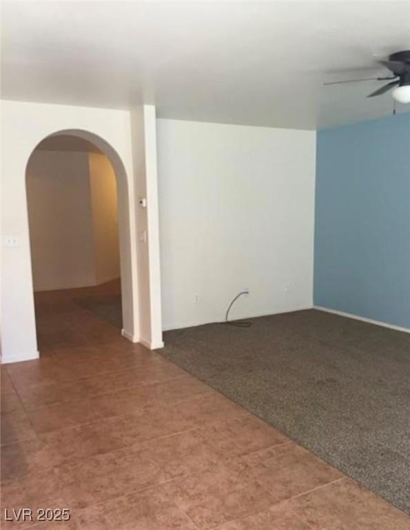 10225 Headrick Dr, Las Vegas, NV 89166 - carpeted spare room with a ceiling fan and arched walkways