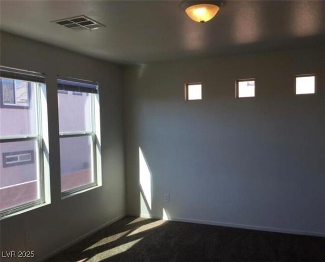 10225 Headrick Dr, Las Vegas, NV 89166 - unfurnished room featuring healthy amount of natural light and carpet flooring