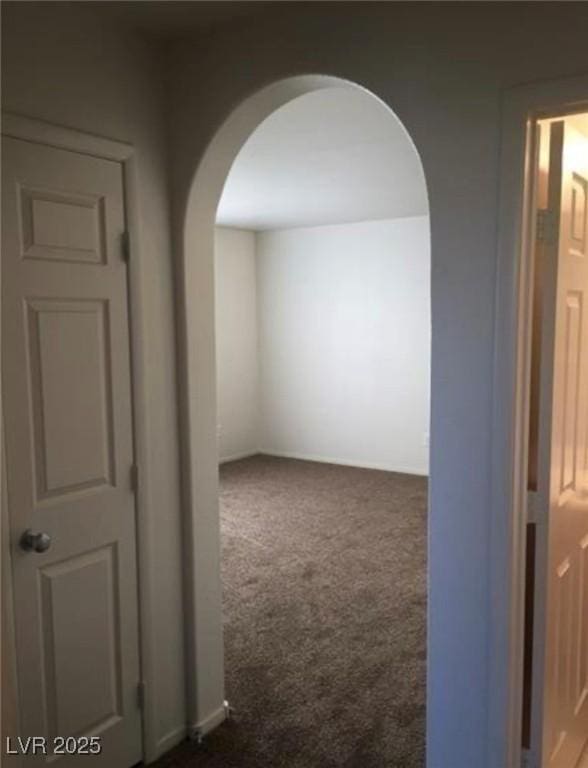 10225 Headrick Dr, Las Vegas, NV 89166 - hallway with arched walkways and dark carpet