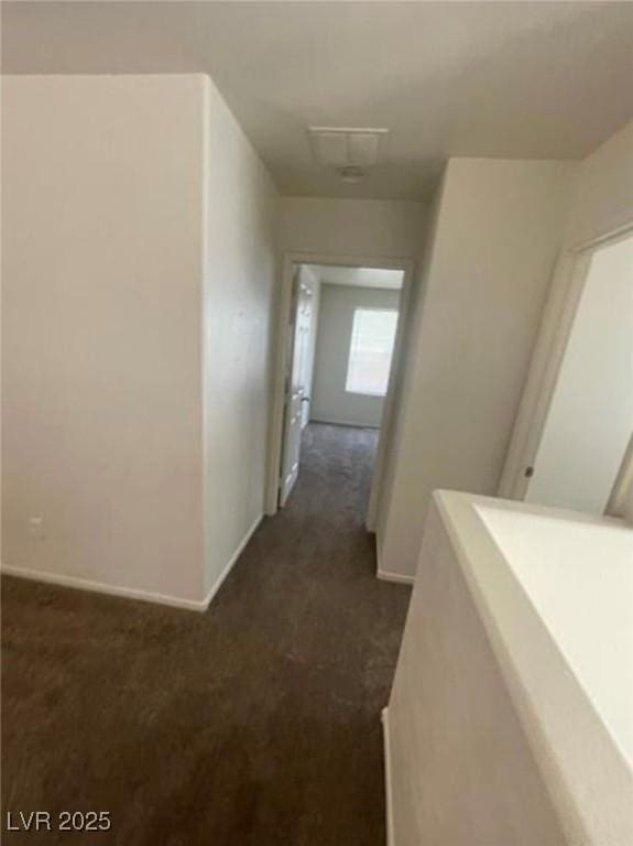 10225 Headrick Dr, Las Vegas, NV 89166 - hallway with dark carpet and baseboards