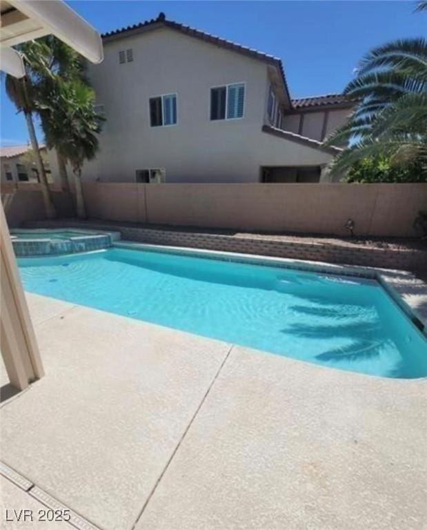 7349 Dolphine Crest Ave, Las Vegas, NV 89129 - view of pool with a fenced backyard, a pool with connected hot tub, and a patio area