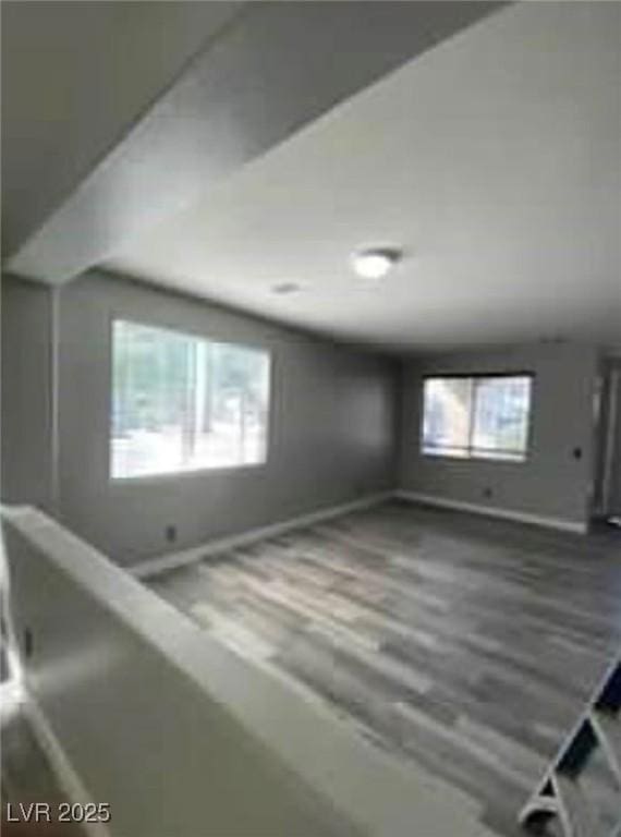 7349 Dolphine Crest Ave, Las Vegas, NV 89129 - unfurnished living room with baseboards and wood finished floors