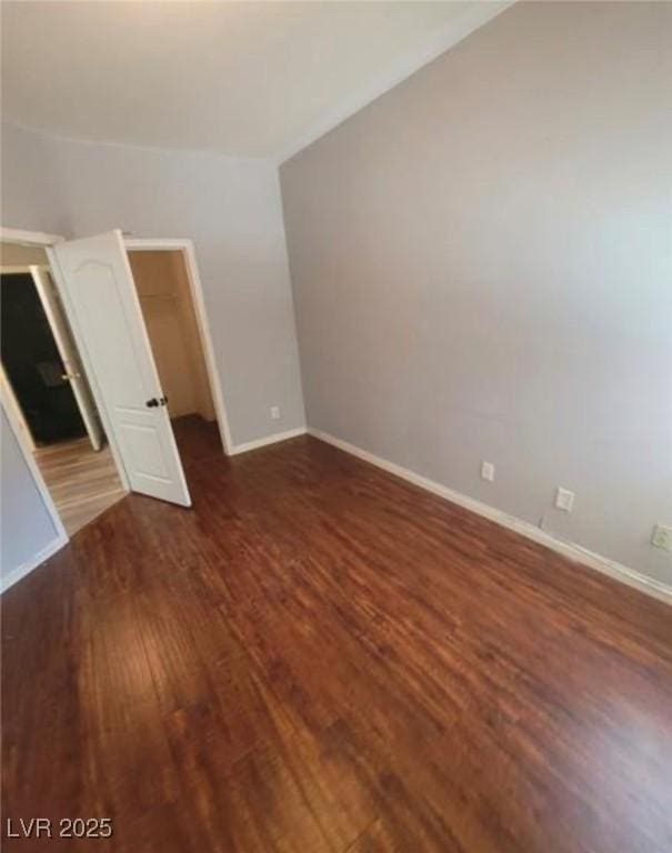 7349 Dolphine Crest Ave, Las Vegas, NV 89129 - unfurnished bedroom with wood finished floors, a walk in closet, and a closet