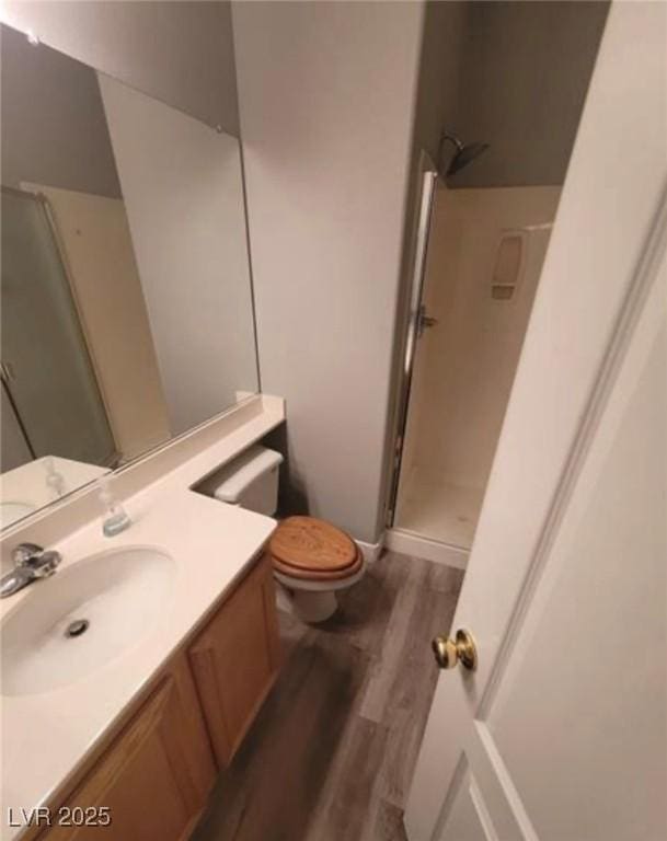 7349 Dolphine Crest Ave, Las Vegas, NV 89129 - full bath featuring wood finished floors, vanity, and a shower stall
