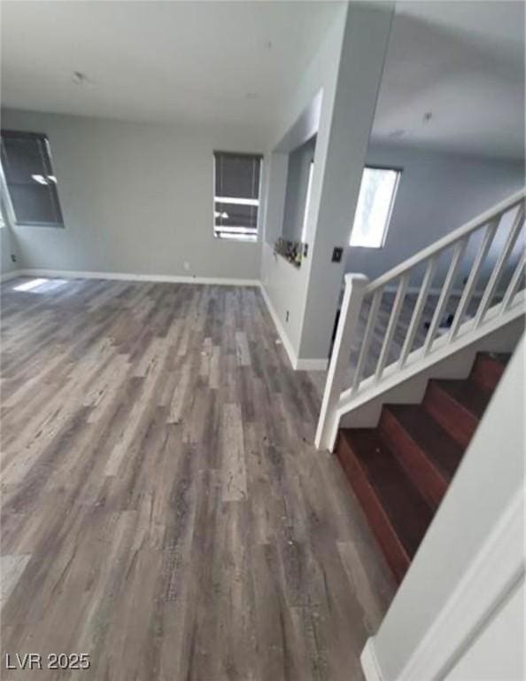 7349 Dolphine Crest Ave, Las Vegas, NV 89129 - unfurnished living room with wood finished floors and stairs