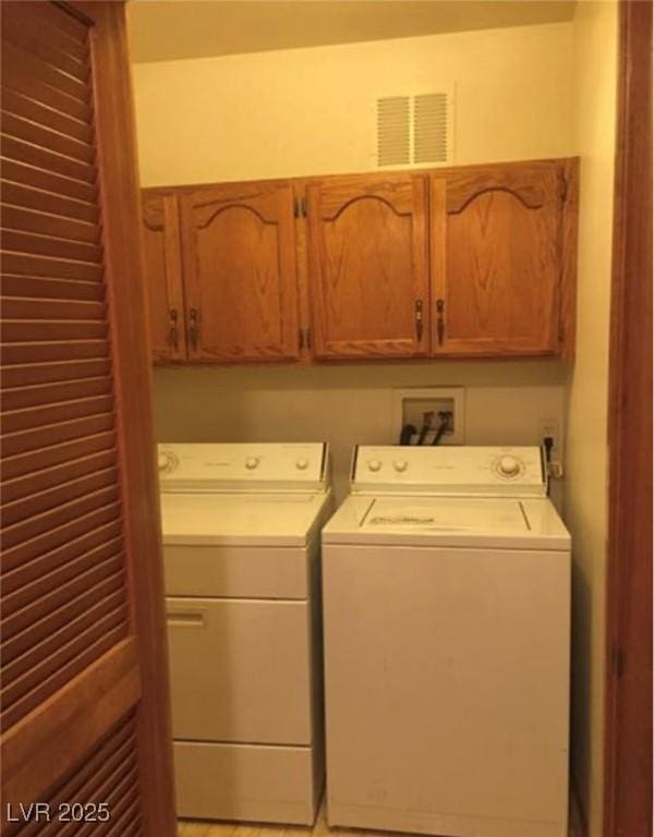 6671 W Tropicana Ave Unit 103, Las Vegas, NV 89103 - laundry area featuring cabinet space and washing machine and clothes dryer